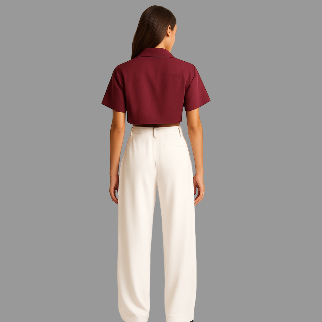 BACK IMAGE OF FEMALE MODEL WEARING WHITE COLOUR LOOSE STRAIGHT FIT WIDE LEGS TROUSER WITH BELT LOOPS AND ONE CUT POCKET AT BACK. MODEL IS WEARING WINE COLOUR CROP SHIRT