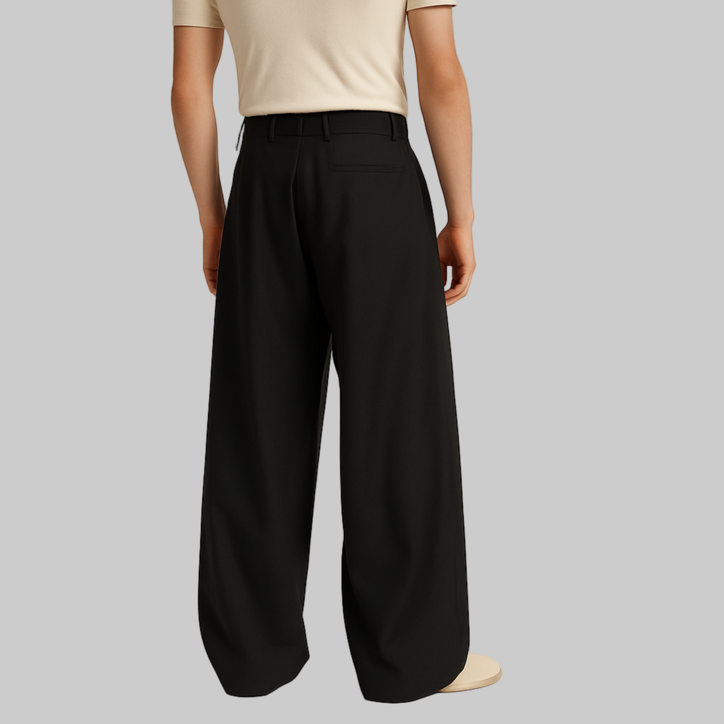 BACK IMAGE OF MALE MODEL WEARING BLACK LOOSE KOREAN TROUSER WITH VERY EXTRA WIDE LEGS WITH SINGLE CUTPOCKET AT RIGHT BACK. BELT LOOPS AT WAIST. MODEL IS WEARING CREAM FITTED T SHIRT AND CREAM SHOES.