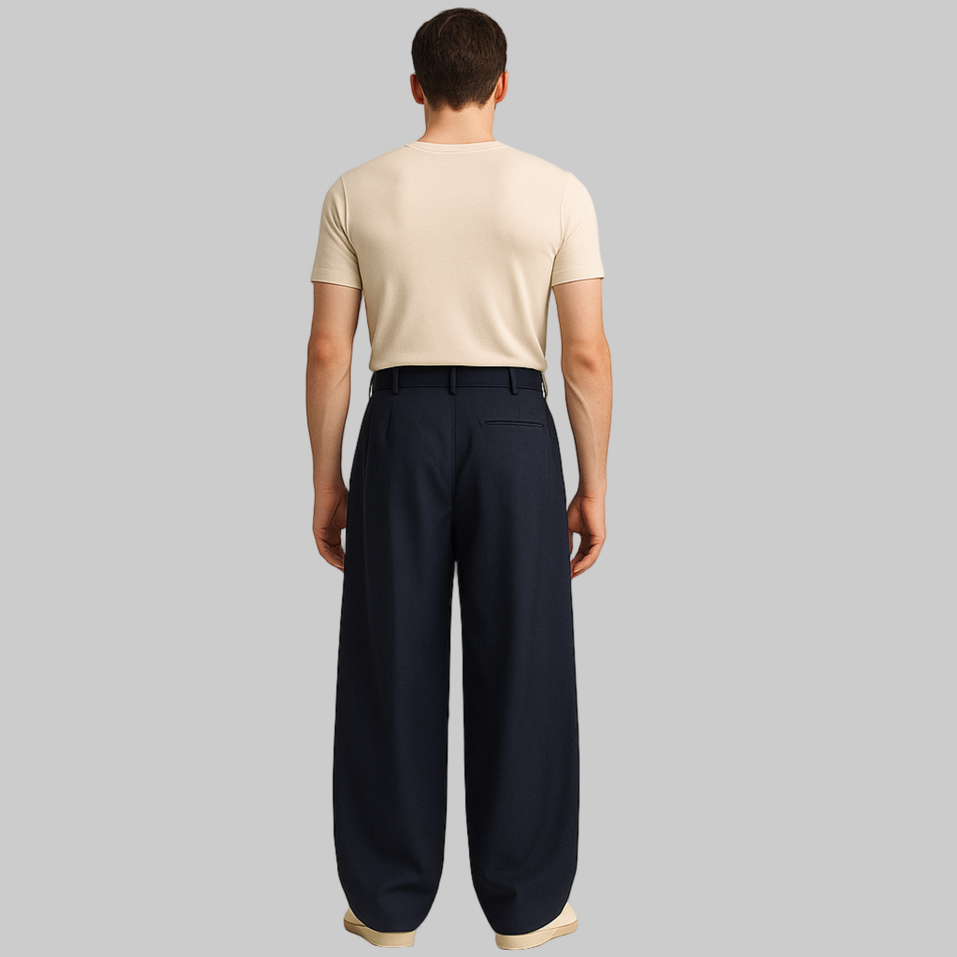 BACK IMAGE OF MALE MODEL WEARING NAVY BLUE  LOOSE KOREAN TROUSER WITH  EXTRA WIDE LEGS WITH SINGLE CUTPOCKET AT RIGHT BACK. BELT LOOPS AT WAIST. MODEL IS WEARING CREAM FITTED T SHIRT AND CREAM SHOES
