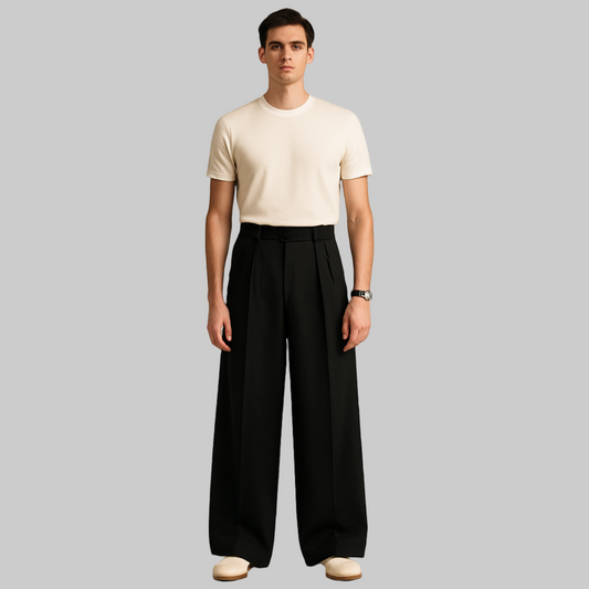FULL IMAGE OF MALE MODEL WEARING BLACK DOUBLE PLEATED LOOSE  EXTRA LENGTH AND VERY EXTRA  WIDE LEGS. KOREAN TROUSER WITH CROSS POCKETS AT FRONT ,BELT LOOPS . MODEL IS 6.4 INCHES TALL WEARING  FITTED CREAM COLOUR HALF SHIRT AND WRIST WATCH WITH CREAM SHOES .