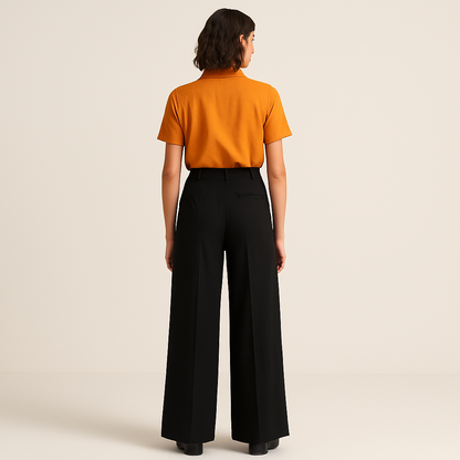 back image of female model wearing black loose straight wide legs trouser with saffron shirt insert in trouser. belt loops and single cut pocket