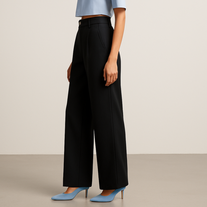SIDE IMAGE OF FEMALE MODEL WEARING BLACK TROUSER. STRAIGHT LOOSE  FROM HIP TO BOTTOM WITH EXTRA  WIDE LEGS. CROSS POCKET AT SIDE ,BELT LOOPS. MODEL IS WEARING LIGHT SKY BLUE HALF SHIRT AND SKY BLUE HIGH HEELS